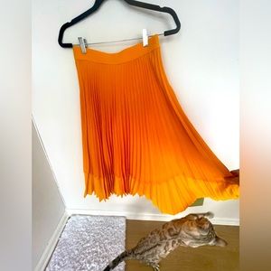 Pleaded orange midi skirt